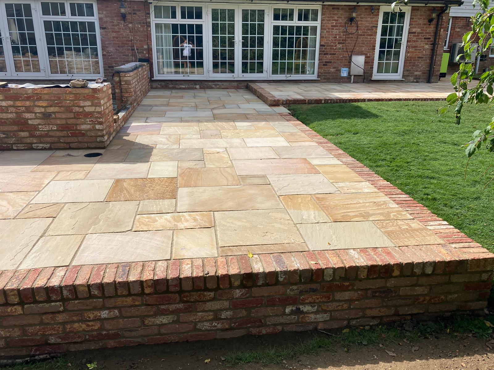 Fossil Sandstone Patio with Country Style Brick Edging - Benenden